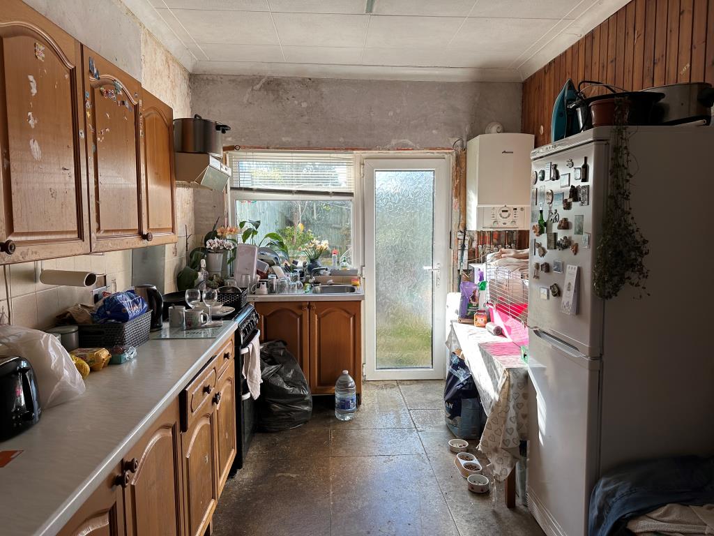 Lot: 146 - THREE-BEDROOM END-TERRACE HOUSE FOR REFURBISHMENT - Kitchen with access into rear garden